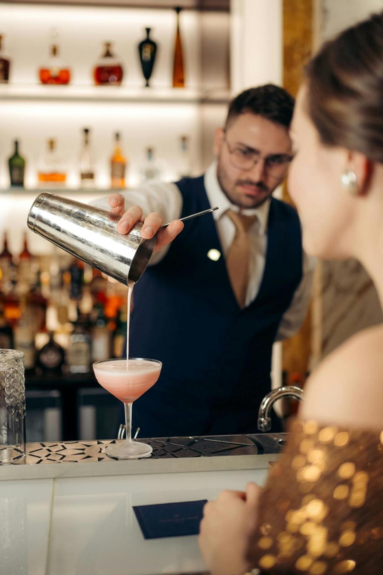 Hotel Imperial, A Luxury Collection Hotel, Vienna Exterior photo A bartender straining a cocktail